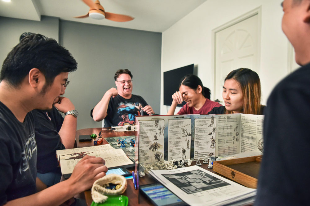 Dungeon Masters like Stephen (in the centre) act as the game masters who determine the outcome of certain player actions. This often leads to situations that require teamwork to overcome. (Photo taken in February 2020)